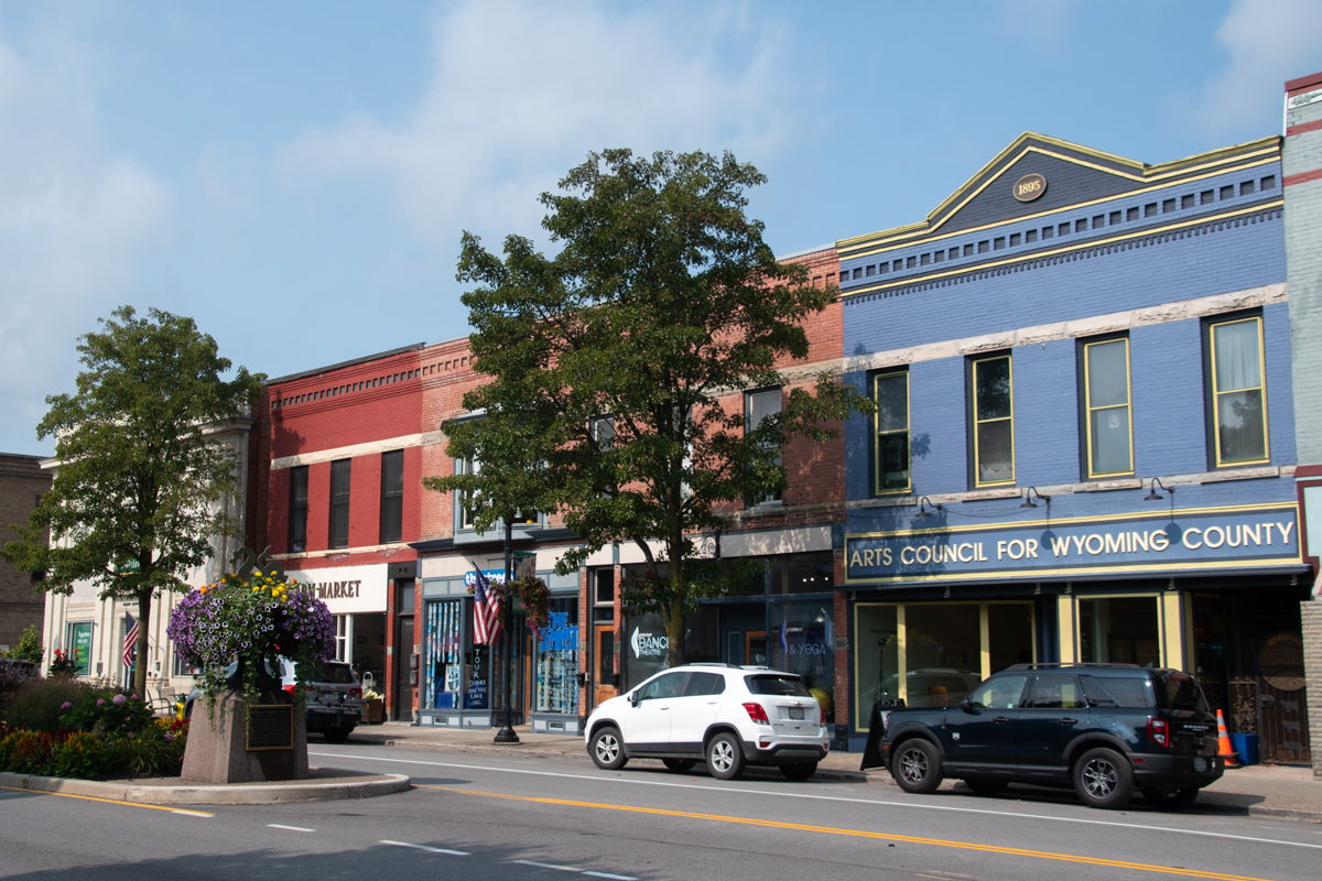 Downtown Perry, New York – Colorful historic Main Street buildings including the Arts Council for Wyoming County, boutique shops, and farm market, capturing the small-town charm of Wyoming County near Letchworth.