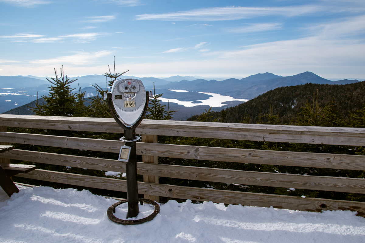 Coin-operated binoculars at Whiteface Mountain overlook with sweeping views of frozen Adirondack lakes