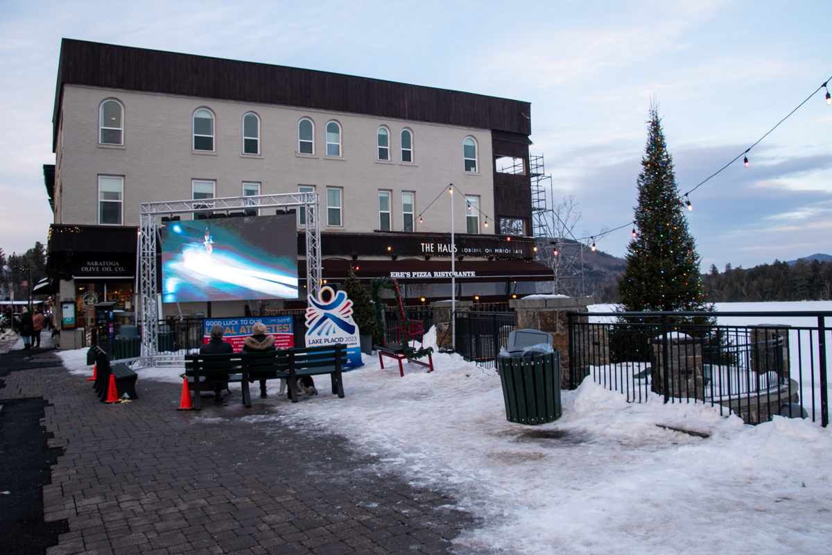 Watching Winter Olympics on outdoor screens along Main Street in Lake Placid during winter