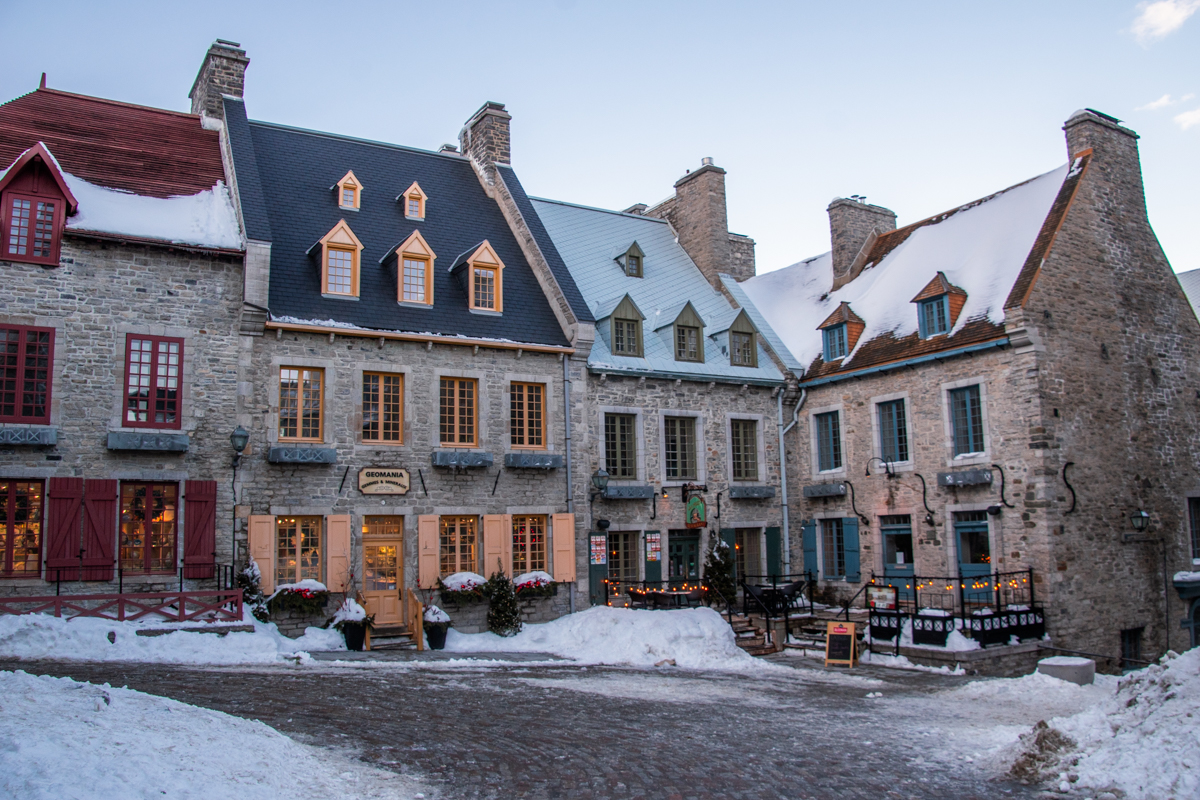 Place Royale in Old Quebec with snow-covered cobblestones and 17th-century stone houses in winter