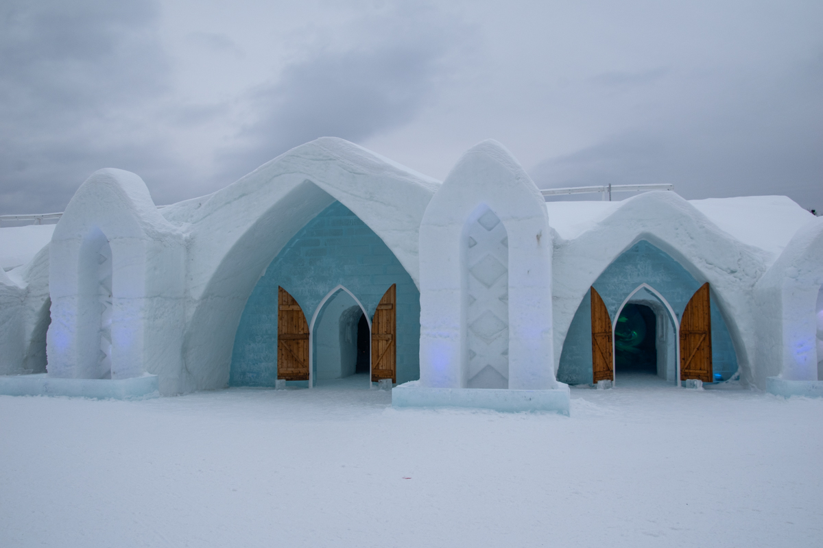 Exterior of Hôtel de Glace Ice Hotel with snow-covered arches in Quebec City