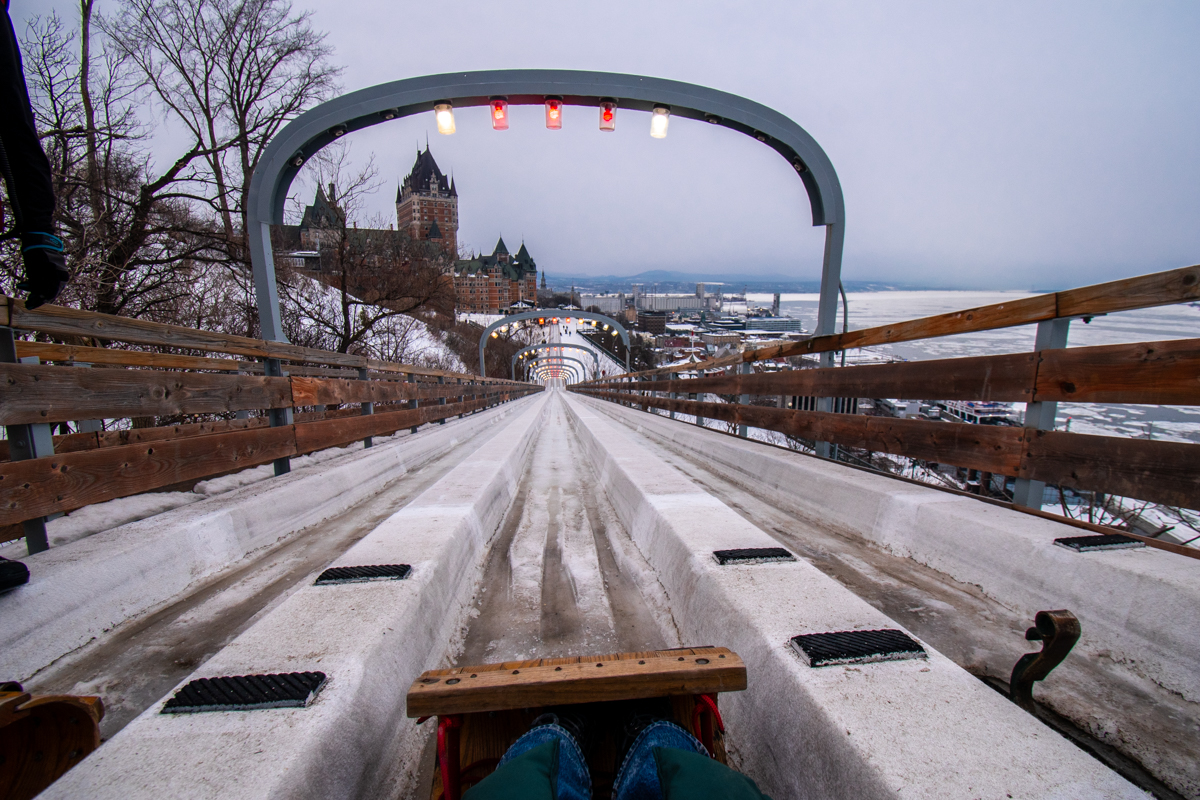 Point-of-view shot from a wooden toboggan at the top of the Dufferin Terrace Toboggan Slide before the ride begins.