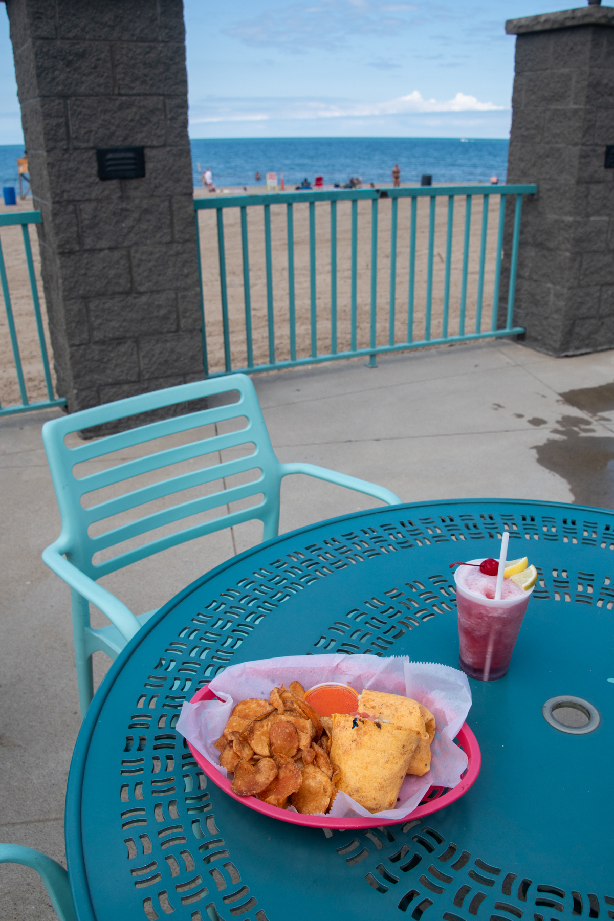 Buffalo chicken wrap, house-made chips, and a frozen sangria slush at Cabana Sam's overlooking Sunset Bay Beach on Lake Erie.