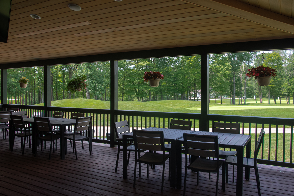Outdoor patio overlooking the rolling greens of the Upper Golf Course at Peek'n Peak Resort.