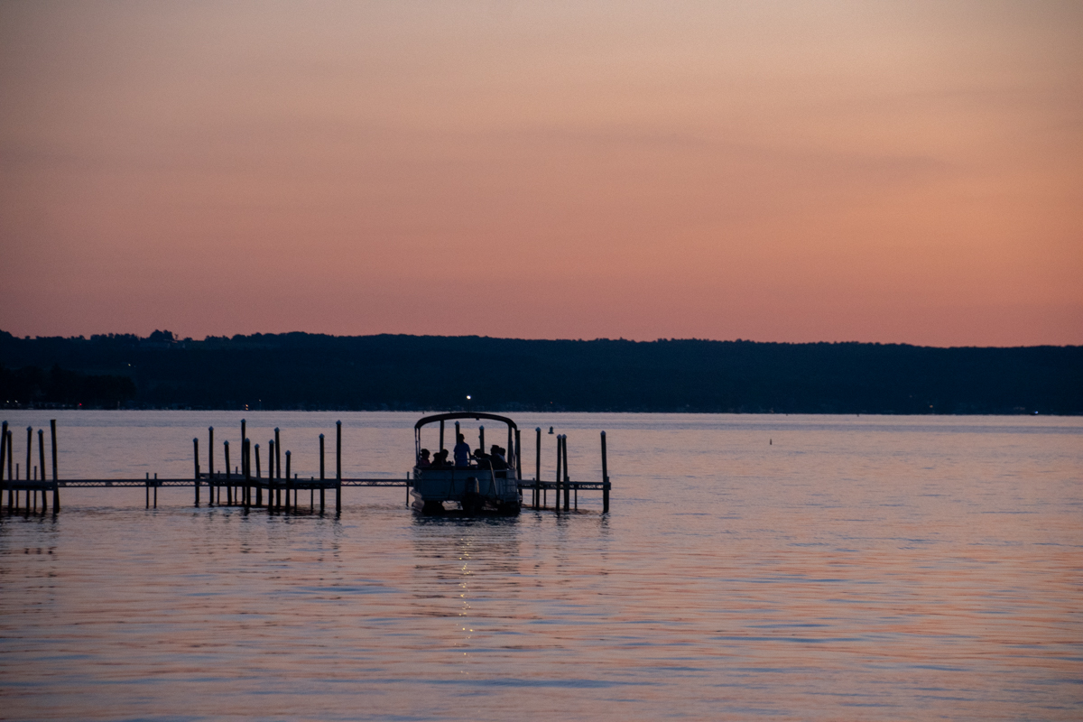 Sunset on Chautauqua Lake with boats in the horizon