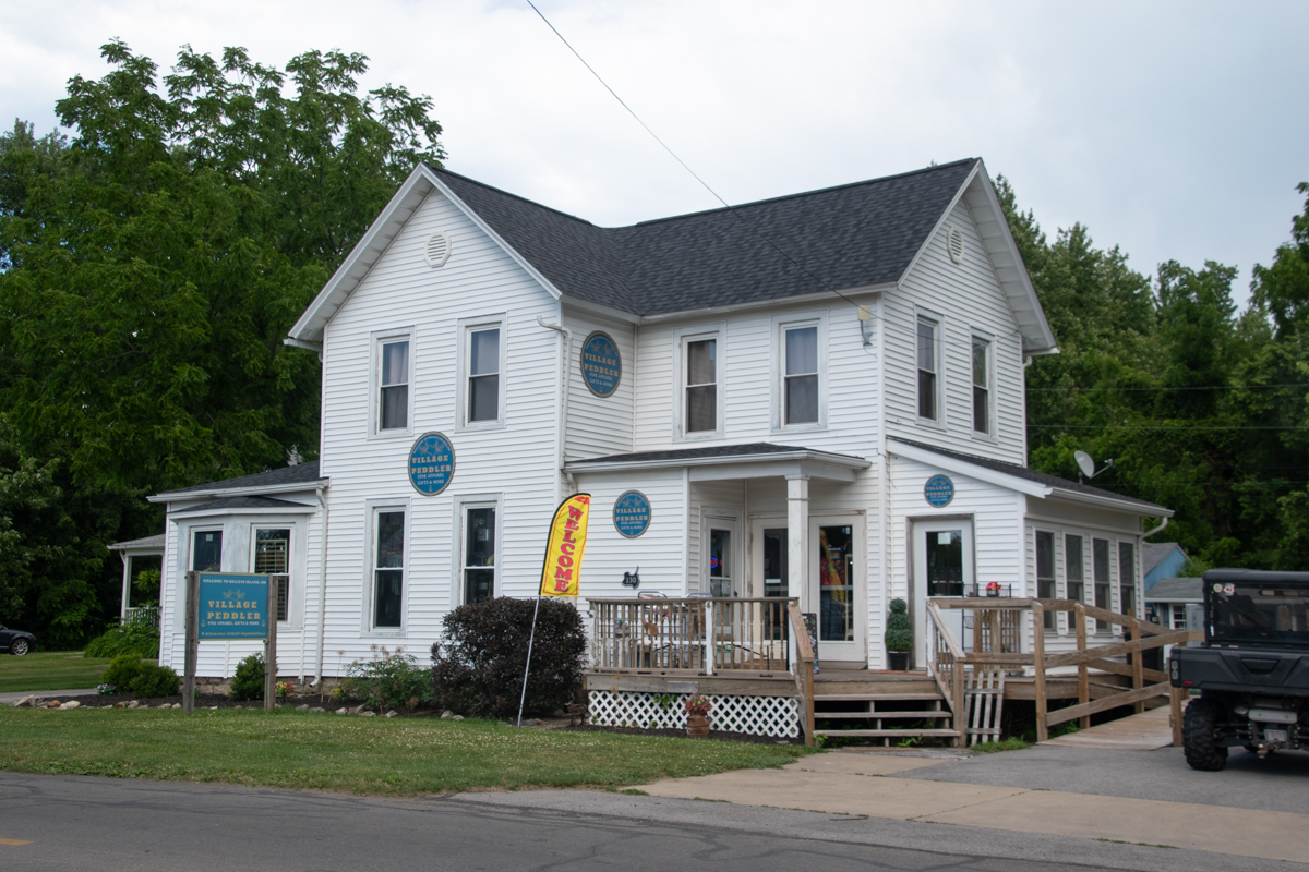 Exterior of Village Peddler gift shop in downtown Kelleys Island, Ohio, featuring apparel, gifts, and local souvenirs.