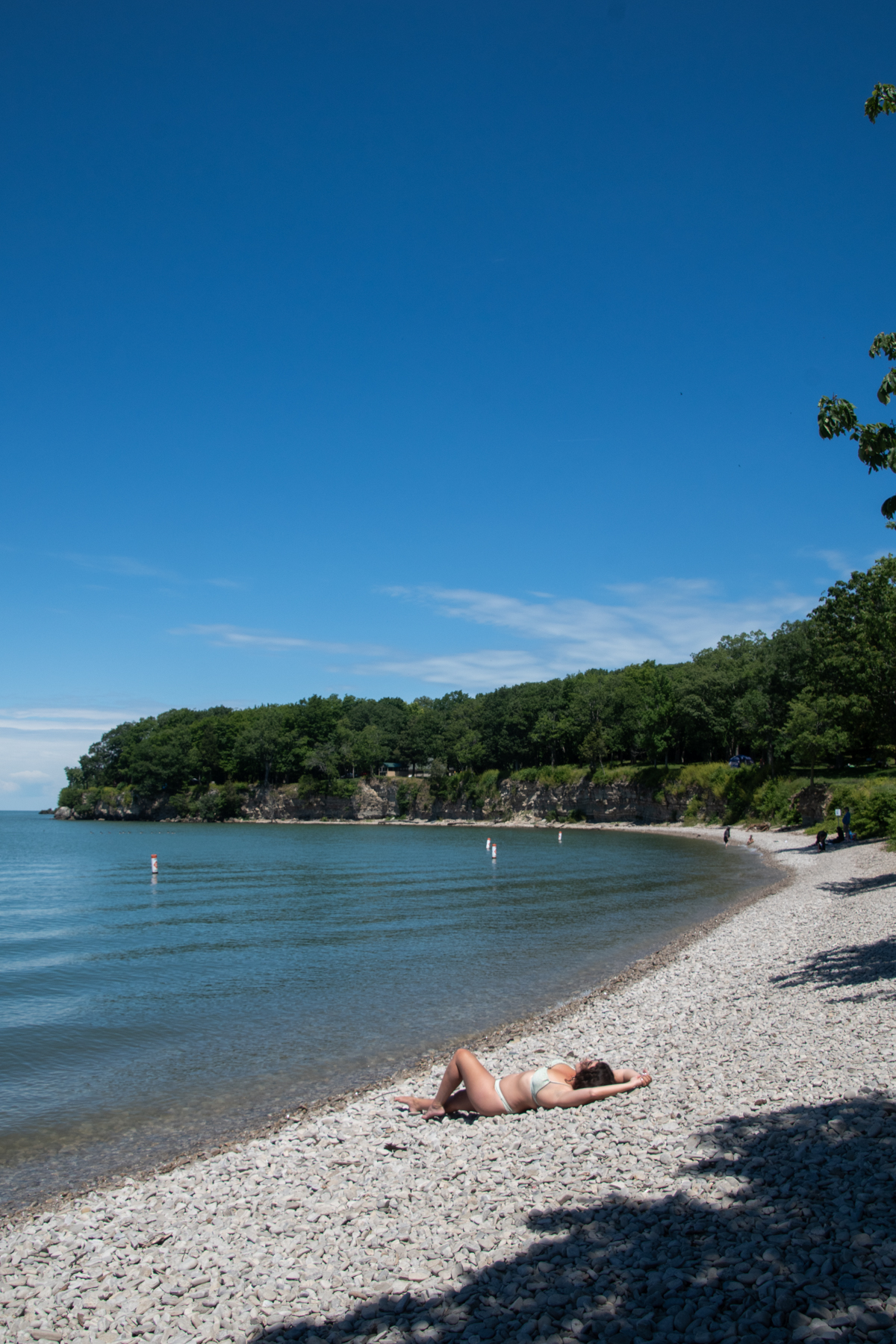 Relaxing on the rocky beach at Put-in-Bay with limestone cliffs and Lake Erie views on South Bass Island.