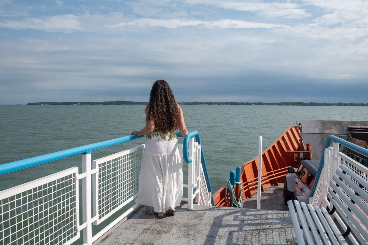 Woman standing on the Kelleys Island Ferry looking out over Lake Erie during the crossing to Kelleys Island, Ohio.