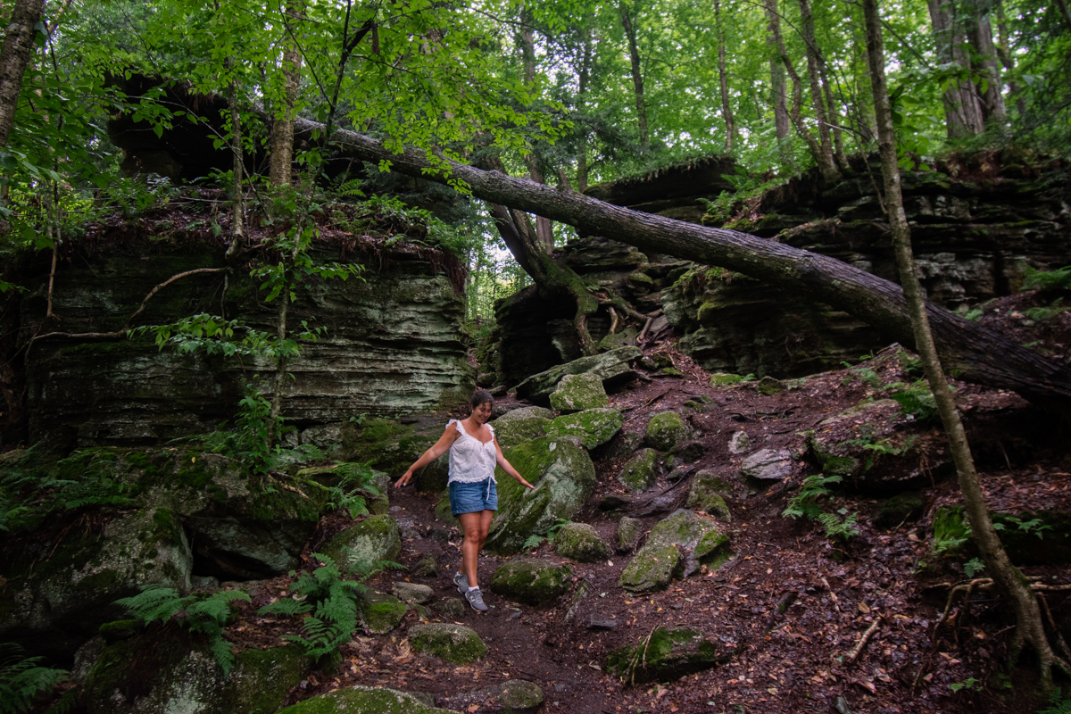 Towering moss-covered rock walls along the trail at Panama Rocks Scenic Park